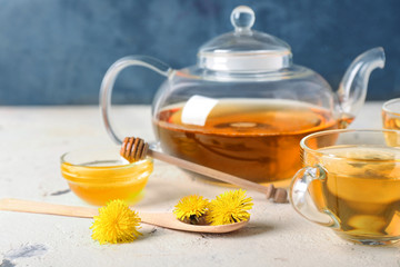 Healthy dandelion tea with honey on table