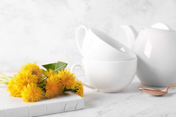 Healthy dandelion tea with flowers on white background
