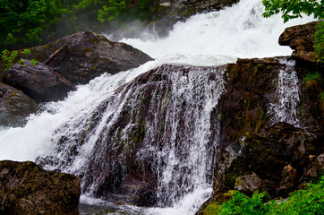 Beautiful waterfalls or cascades in Geiranger while cruising to the Norwegian Fjords in...