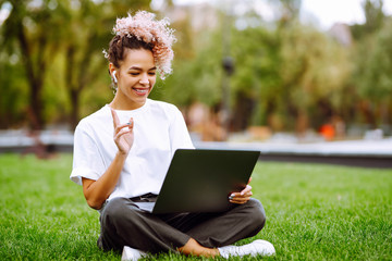 Girl speak talk on video call with colleagues on online briefing  on modern laptop sitting in the...