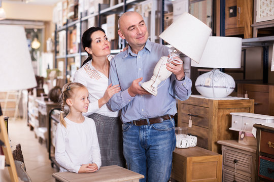 Family choosing lamp in store