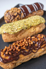 delicious and beautiful eclairs with chocolate and pistachio glazes
