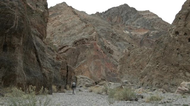 Two male hikers walk through Fall Canyon in Death Valley National Park in California.