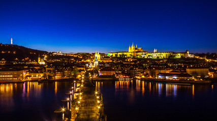 Fototapeta na wymiar Night view of Prague castle and Charles Bridge over Vltava river