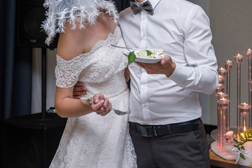 bride and groom cut a wedding cake