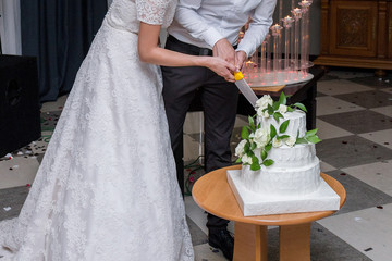bride and groom cut a wedding cake