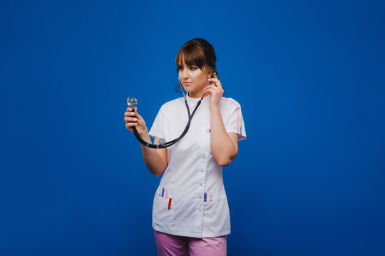 Female Doctor Gesturing Check Up Heart Beat In Doctor Office At Hospital By Using Stethoscope, Isolate On White Background. Doctor Ready For Curing Patient. Medical Doctor Love Her Job With Happiness