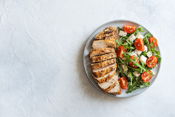 Close-up on a salad with chicken and tomato