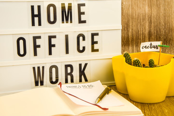 lightbox with text HOME OFFICE WORK with notebook pen and cactus and TO DO list, copy space wooden...