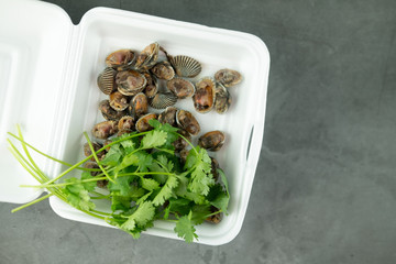 Fresh and delicious boiled​ cockles​ shell eating in foam box.