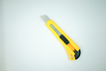 yellow utility knife on white background.