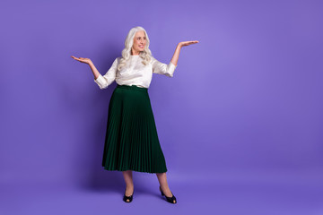 Fototapeta na wymiar Full length body size view of her she nice attractive chic lovely charming grey-haired woman holding copy space on palms isolated on bright vivid shine vibrant lilac violet purple color background