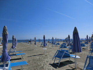 Blue hammocks and parasols on the beach