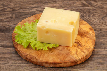 Emmental cheese over wooden board