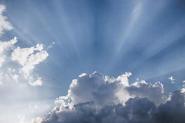 Besutiful ray of sunlight breaking through clouds at sunset.