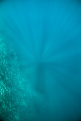Underwater shot of light rays shining through the water