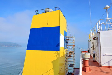 Repainting the ship’s funnel and drawing the logo of the shipowner with members of the ship’s...