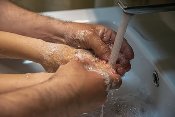 Fototapeta premium washing hands with soap. Washing a child’s hands with soap and water to prevent coronavirus and hygiene to stop the spread of coronavirus. wash your hands with soap and hot water