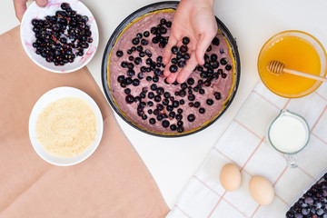 the stages of preparation of a pie with black currants and shortbread crust , fresh berries. the view from the top .