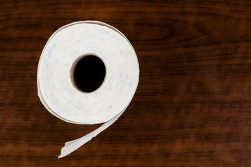 White toilet paper on a wooden table