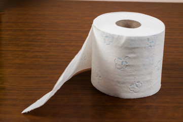 White toilet paper on a wooden table