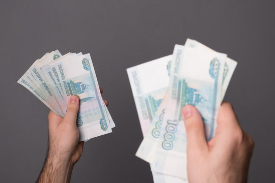 Male hand holds money. Man holds Russian rubles. Russian money, large banknotes in a hand.