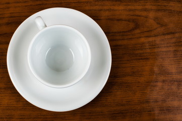 White coffee cup and coffee beans on a wooden table.Coffee time