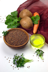 Radish oil, radish seeds in ceramic bowl, radish microgreen, potato and carrot