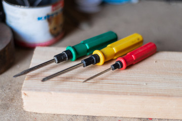 different screwdrivers with colored handles in the workshop