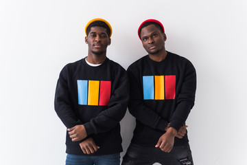 Street fashion and friendship concept - Two happy african american young men in black stylish sweatshirts.