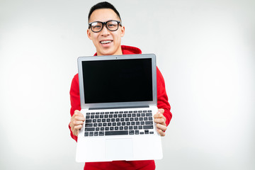 stylish brunette man shows a blank laptop screen in hands on a white studio background