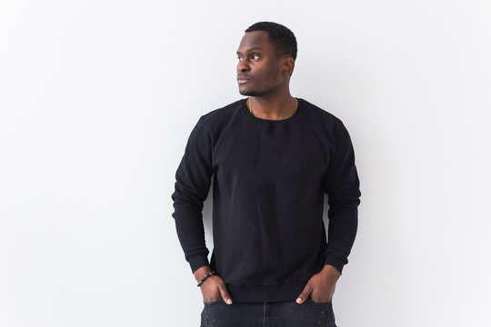 Youth street fashion concept - Portrait of confident sexy black man in stylish sweatshirt on white background with copyspace.