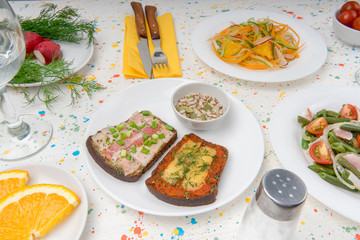 Prepared salads of green beans, tomatoes, carrots, sandwiches with bacon cheese and herbs. Vitamin snacks from cherry tomatoes, radishes, oranges and cereals. Healthy nutritious delicious food