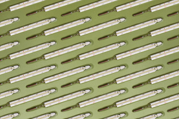 Pattern with a medical classic mercury thermometer with a Celsius scale. Concept of recovery from bacterial or viral coronavirus disease