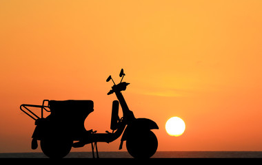 silhouette classic motocycle on sunrise background