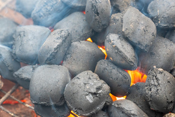 Glowing Hot Charcoal Briquettes Close-up Background Texture