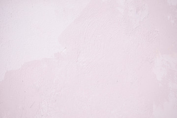 Pink concrete wall with chipped and scratches. Aged texture and background