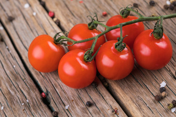 Cherry tomatoes on wooden table, low depth of focus