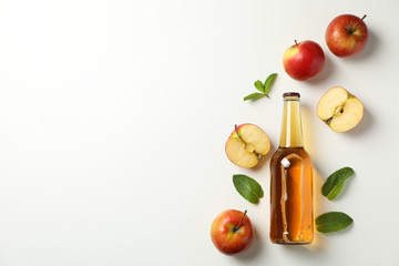 Composition with cider and apples on white background