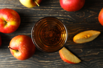 Composition with cider and apples on wooden background