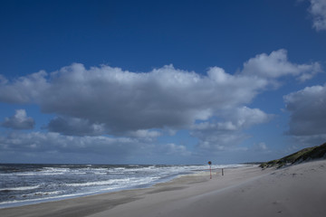 Northsea coast Netherlands. Julianadorp. Beach. Breaking waves. Clouds