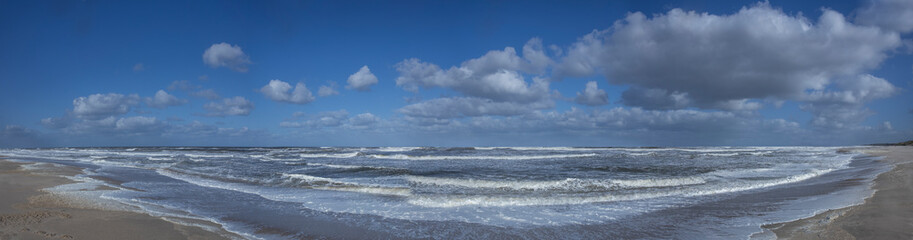 Naklejka na ściany i meble Northsea coast Netherlands. Julianadorp. Beach. Breaking waves. Clouds Panorama. Sea.