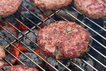 A beef burger grill cooking close up