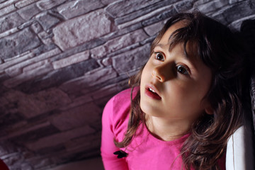 a 5 year old girl looks up at the moon and the stars