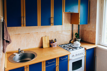 Retro simple kitchen interior design with ugly messy cabinets in need of remodel. - obrazy, fototapety, plakaty