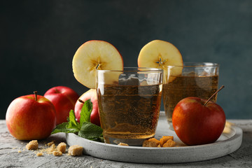 Composition with cider, sugar and apples on gray table