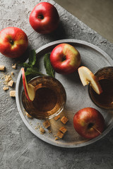 Composition with cider, sugar and apples on gray table