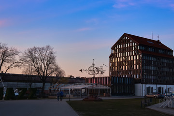 Fototapeta na wymiar Beautiful sunset over port area and typical fachwerk building in spring in Klaipeda, Lithuania