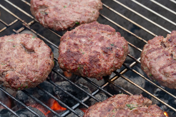 cooking burgers on hot grill 