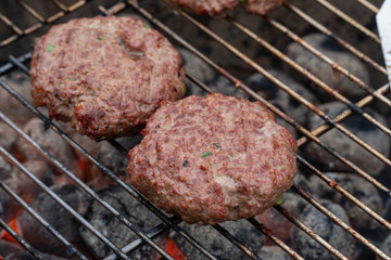 cooking burgers on hot grill 